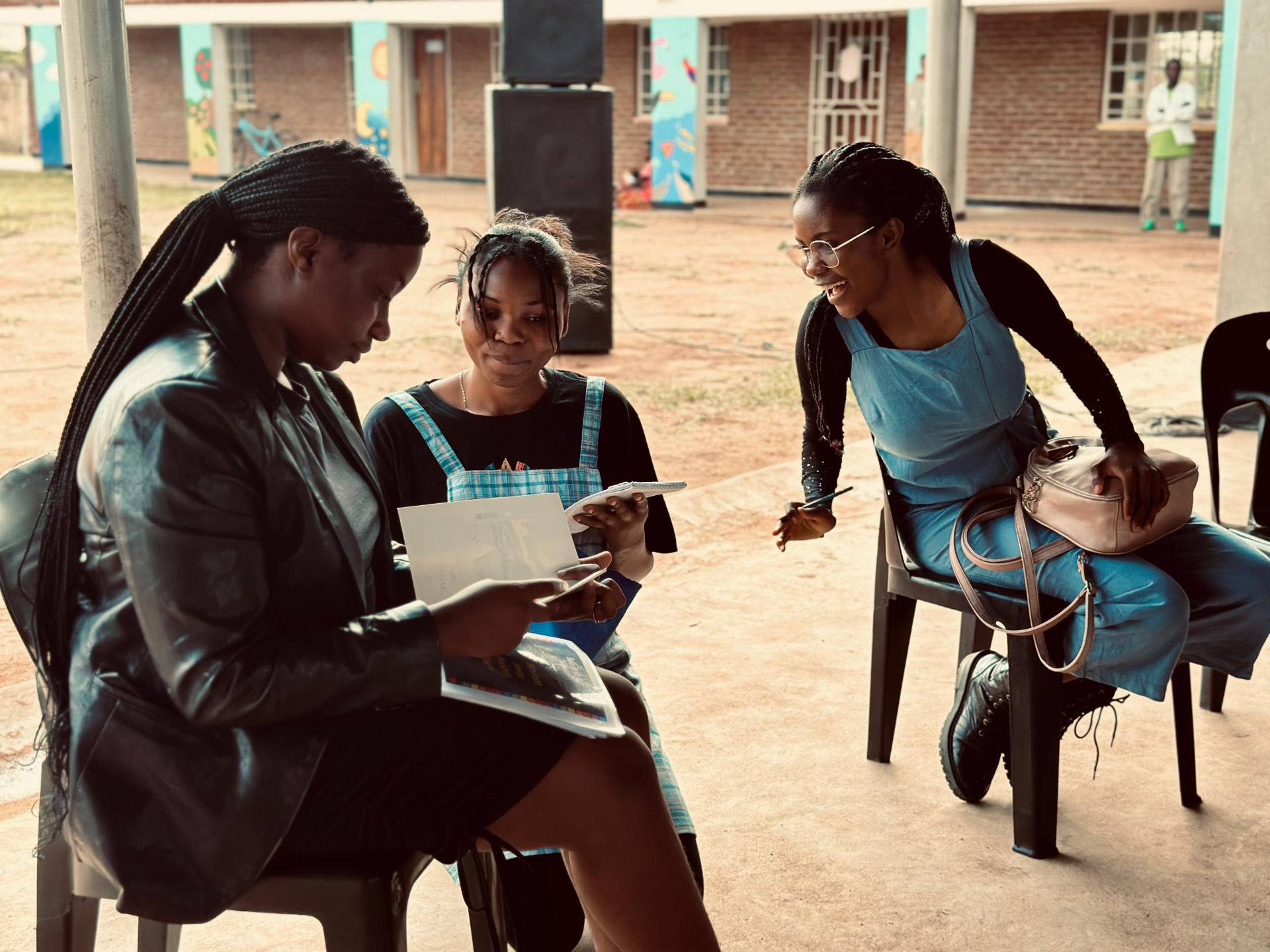 Young Malawian filmmakers reviewing scripts at a mentorship workshop